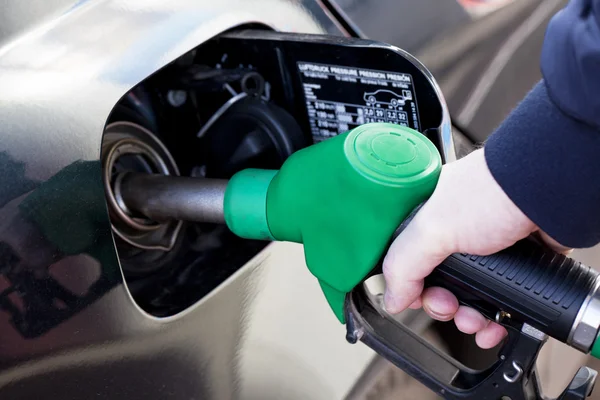 Man filling up car with fuel at petrol station