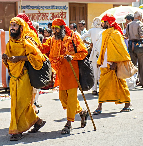Pilgrims in traditional yellow and orange clothes