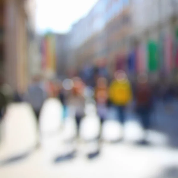 Walking blurred people in city