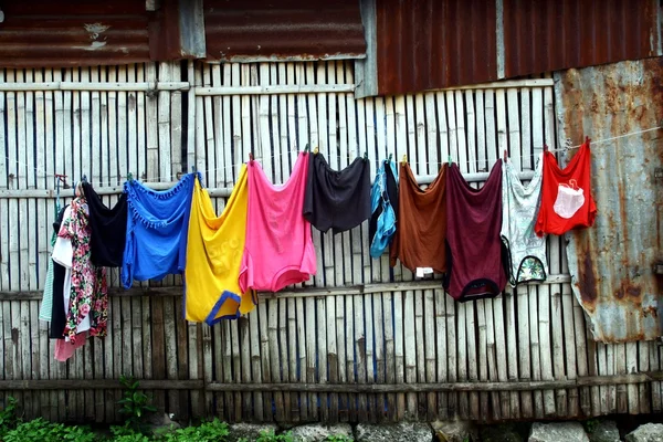 Clothes in a clothes line being hung to dry