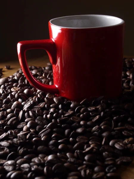 Coffee beans and a red coffee mug