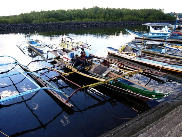 Fishing boats dock at at fish port or pier and replenish their supplies before heading out to sea again.