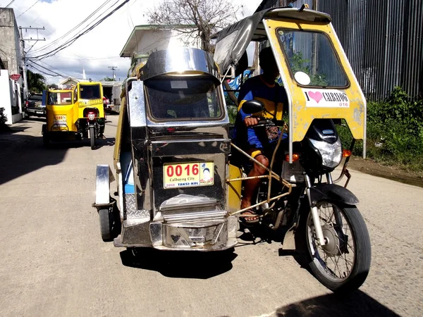 A motorcycle fitted with additional wheels and a cab is turned into what is called a tricycle. A means of transportation for most locals in the province of Samar, Philippines.