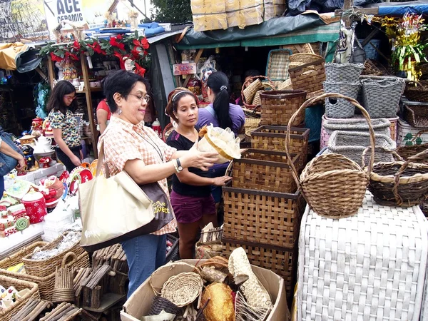 A customer inspects a home decor product at a store in Dapitan Market