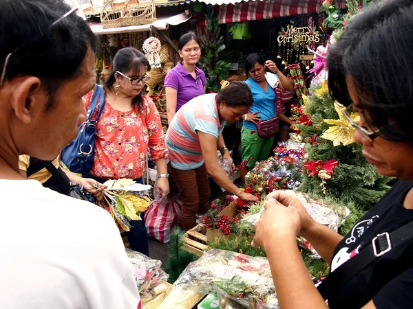 Customers look at a wide variety of chirstmas decors at a store in Dapitan Market