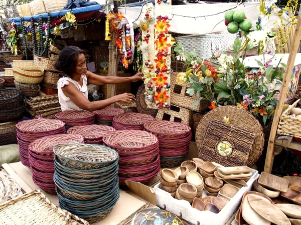 A woman sells christmas decors and baskets in Dapitan Market.