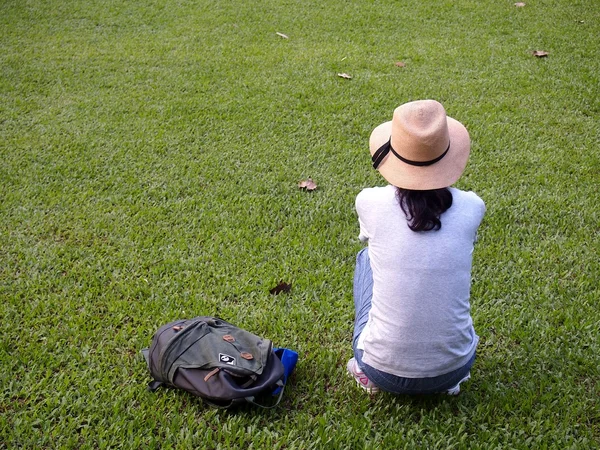 A tourist takes a rest on the grass