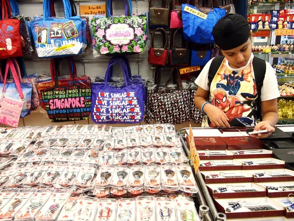 Tourists choose from a variety of souvenir products at a store or shop in Chinatown, Singapore.