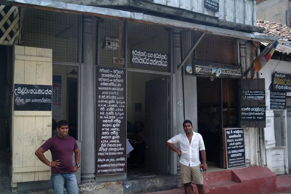 A typical scene of Sri Lankan men sitting outside a local shop in the countryside of Kandy.