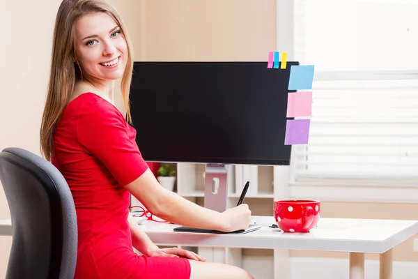 Happy woman working in her home office