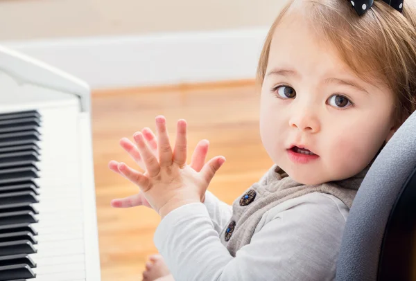 Toddler girl excited about learning piano