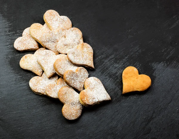 HANDFUL OF HEART COOKIES OVER SLATE SURFACE