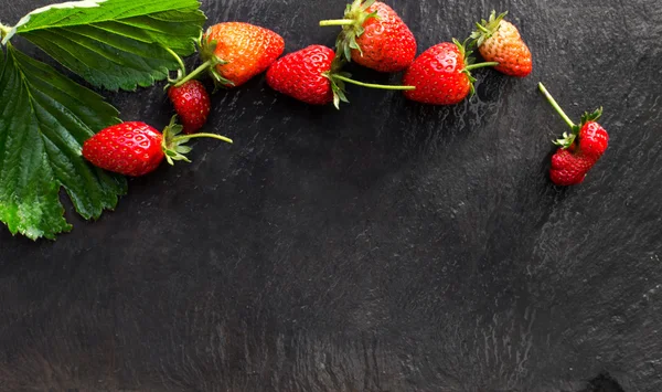 Restaurant frame menu with strawberries over slate