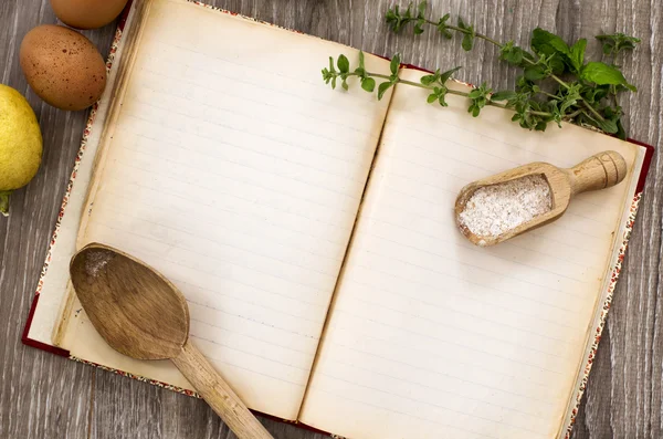 Recipe book and genuine ingredients over wood