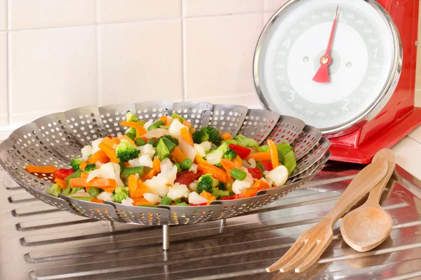 Vegetable steamer with vegetables mix inside and balance
