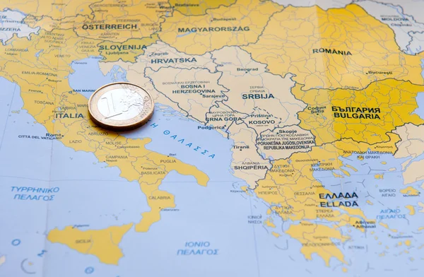 Euro coin on European map