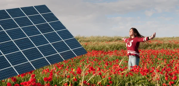 Solar energy panel and teenage girl on a field with red poppies.