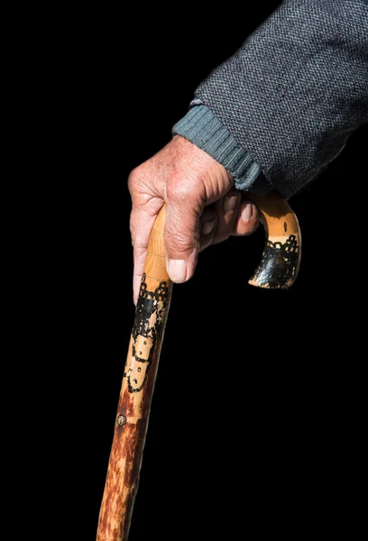 Senior man holding a wooden walking stick