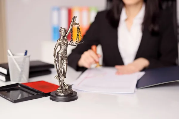 Statuette of Themis - the goddess of justice on lawyer's desk