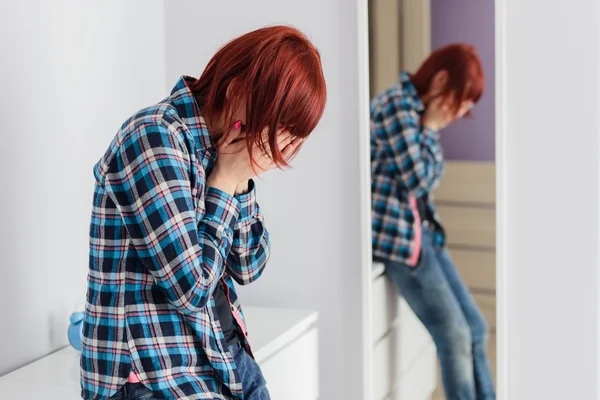 Crying scared redhead woman