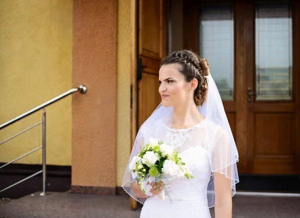 Happy young Bride standing in front of the church