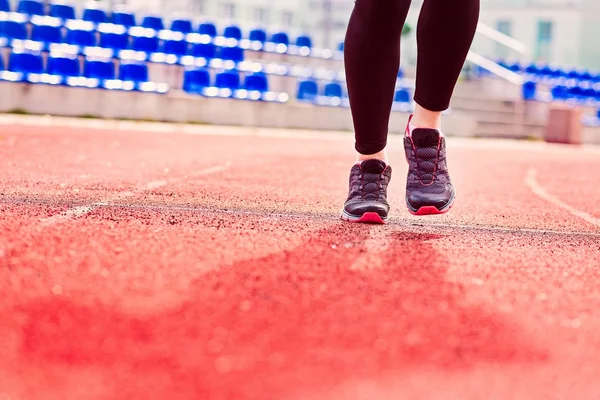 Runner feet running on stadium