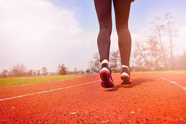 Runner feet running on stadium