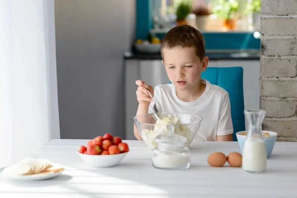 Child mixing white cottage cheese in a bowl