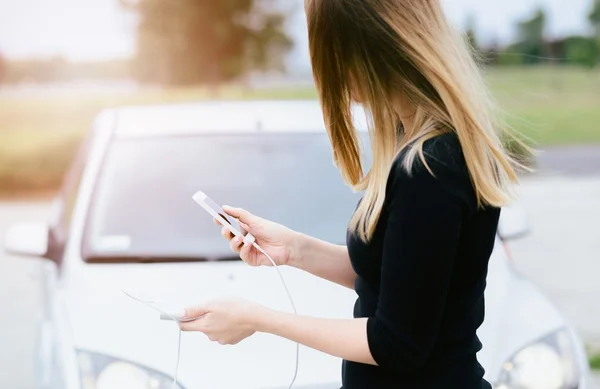 Woman with phone and power bank playing the mobile games