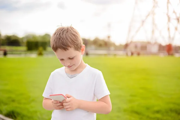 Little boy child playing mobile games on smartphone