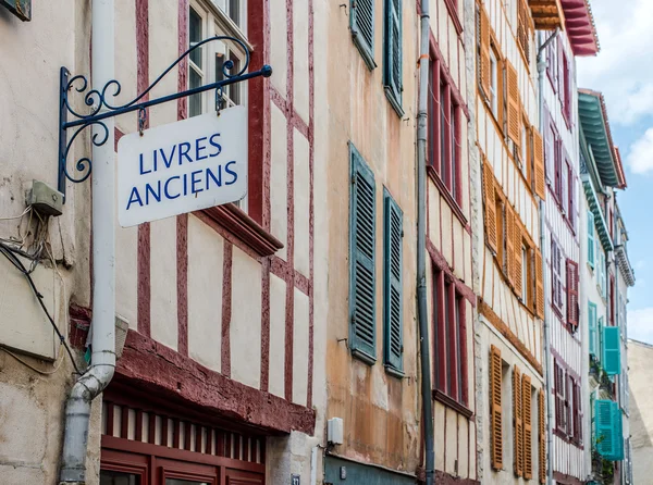 Antique books signboard in a facade of typical building of Aquitaine.