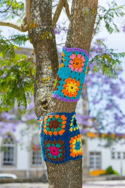 Yarn bombing in a tree. European park.