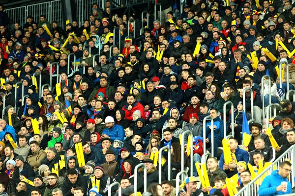 Crowd of people, supporters in a stadium during a football match