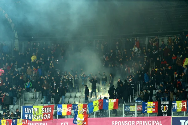 Crowd of people, supporters in a stadium during a football match