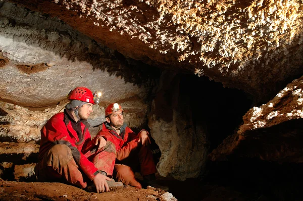 Geologists studying minerals in a cave
