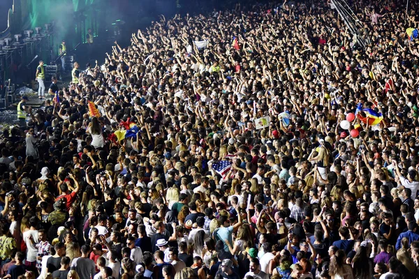 Large crowd of people at a concert in the front of the stage