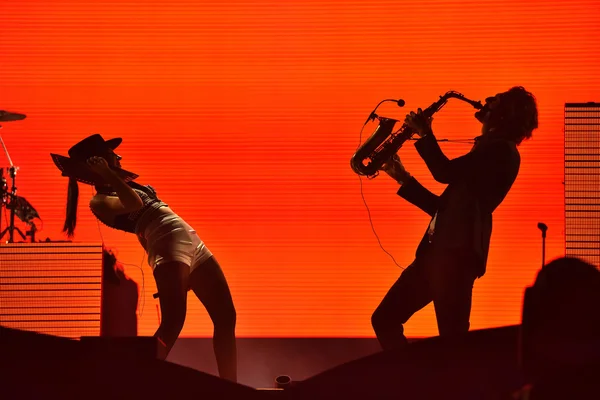 Silhouette of a saxophone player and and a woman singer on the s