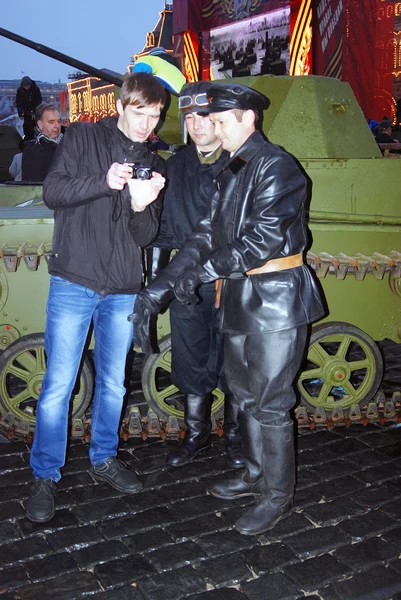 People in vintage military uniform pose on the Red Square in Moscow