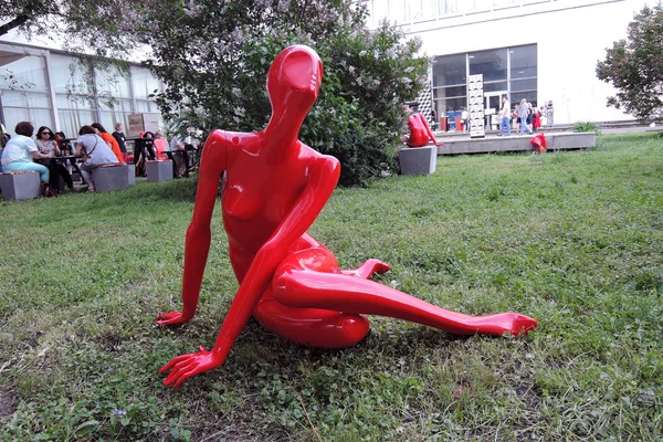 Red plastic woman figure. Arch Moscow 2015