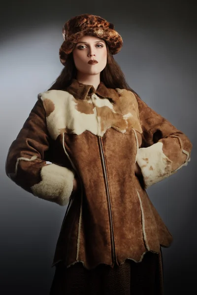 Sheepskin coat winter fashion woman in winter hat