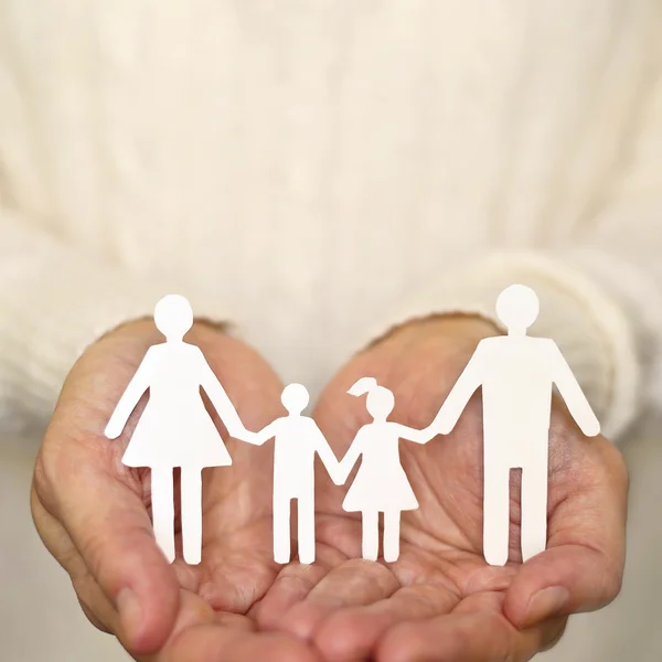 Close up of woman hands holding paper family