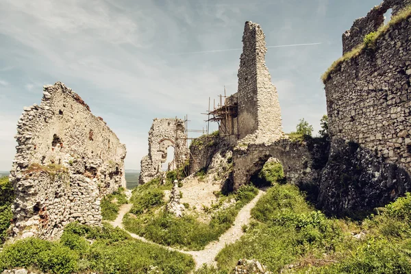 Plavecky castle in Slovak republic, ruins with scaffolding, trav