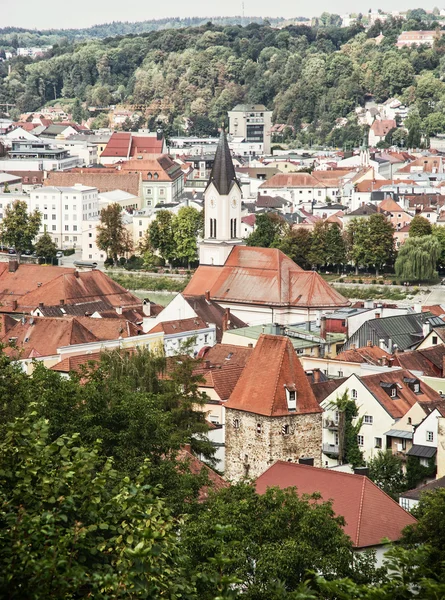 Roofs in Passau city with church tower, architectural scene in G