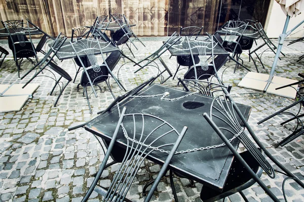 Set of metal garden chairs and tables in restaurant, it is close
