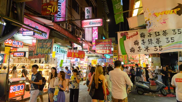 TAICHUNG, TAIWAN - JULY 12: Pedestrians at a Fengjia Night Market JULY 12, 2014 in Taichung, TW. Night markets are an important part of the culinary culture of Taipei.
