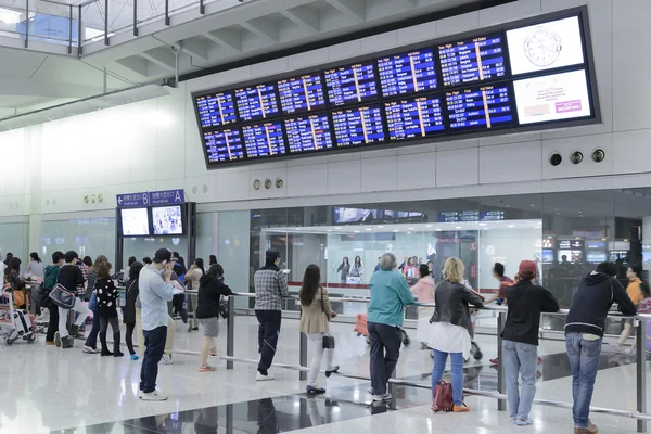HONG KONG, CHINA - APRIL 14: Passengers in the airport main lobby on April 14, 2014 in Hong Kong, China. The Hong Kong airport handles more than 70 million passengers per year.