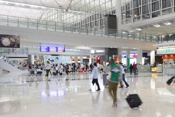 HONG KONG, CHINA - FEBRUARY 11: Passengers in the airport main lobby on February 11, 2013 in Hong Kong, China. The Hong Kong airport handles more than 70 million passengers per year.