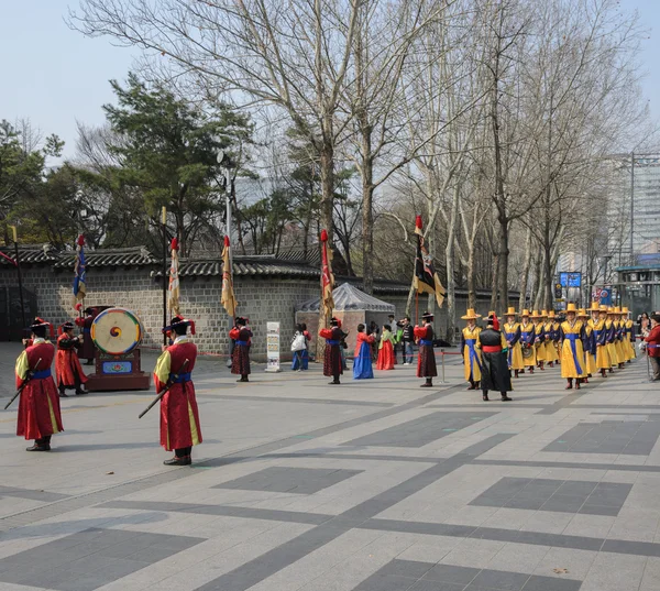 SEOUL, KOREA - MARCH 01: Armed soldiers in period costume guard the entry gate at Deoksugung Palace, a tourist landmark, in Seoul, South Korea on March 01, 2013