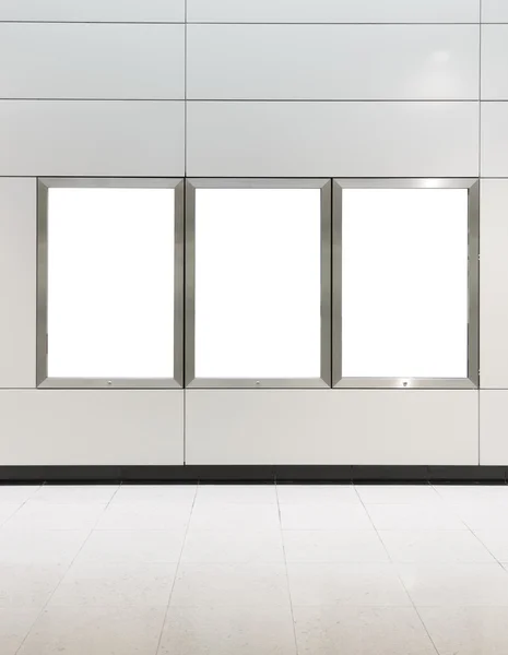 Three big vertical / portrait orientation blank billboard on modern white wall