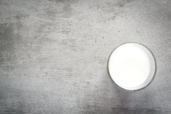 Glass of milk on a concrete table